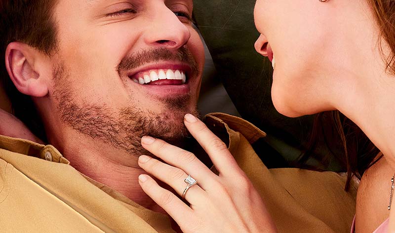 Happy couple with woman wearing 14K white gold engagement ring with lab grown diamonds