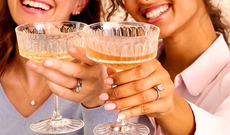 Woman wearing hidden halo lab diamond engagement ring on her hand by With Clarity