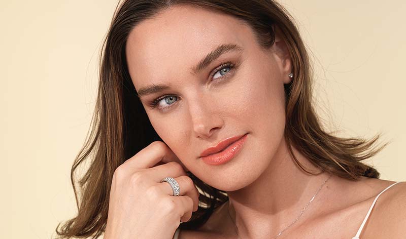 Woman wearing diamond eternity ring on hand