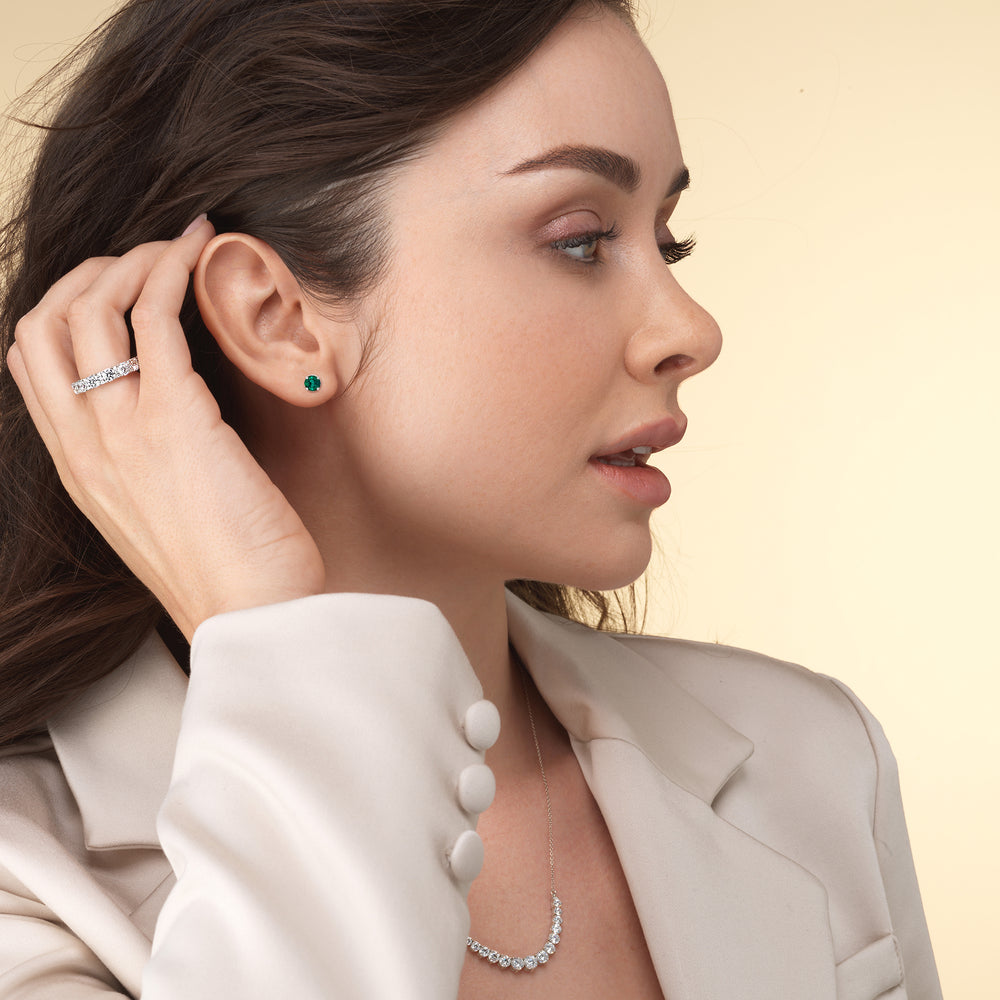 Model Wearing Round Shape Emerald and Lab Diamond Classic Solitaire Under-Halo Earrings view