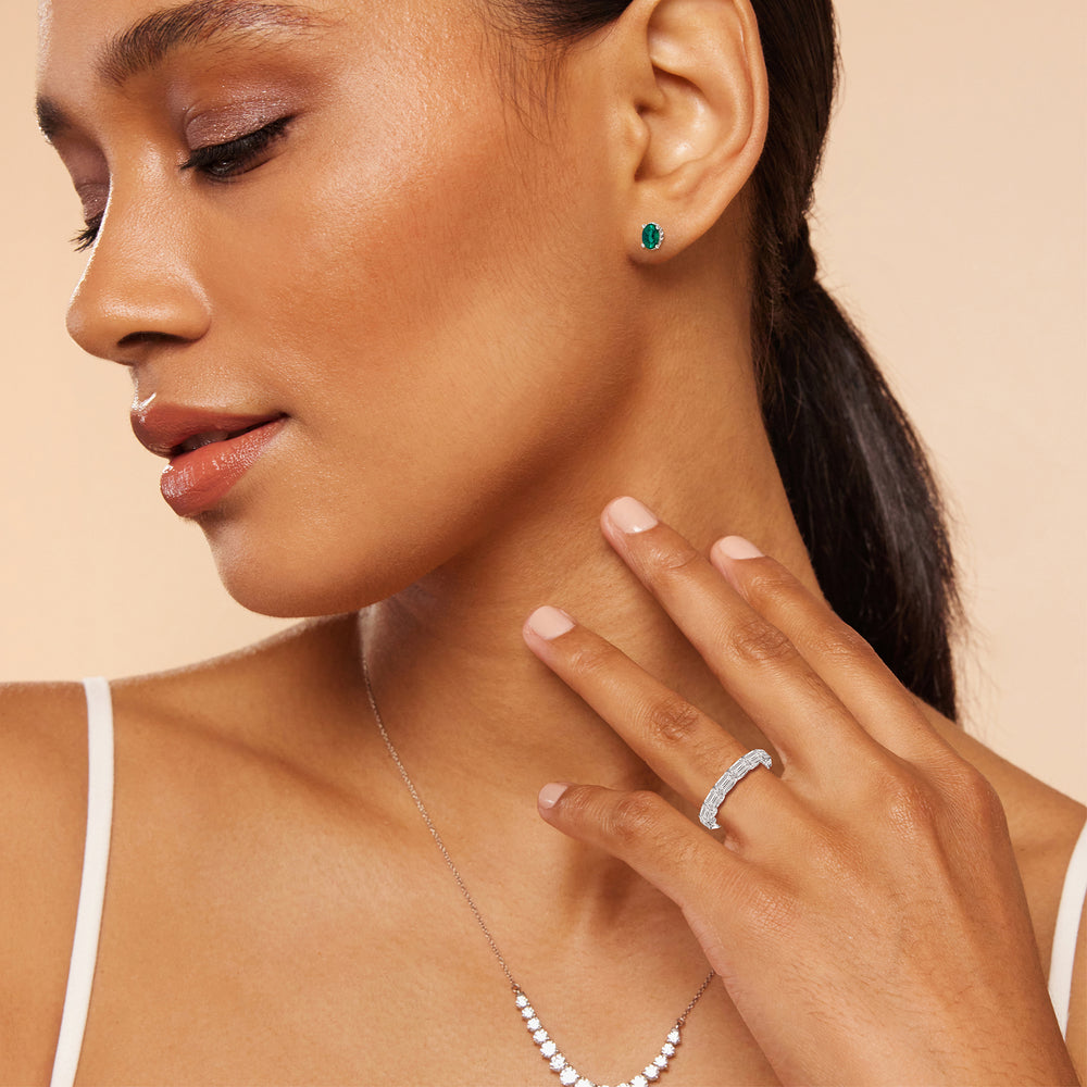 Model Wearing Oval Shape Emerald and Lab Diamond Classic Solitaire Under-Halo Earrings view