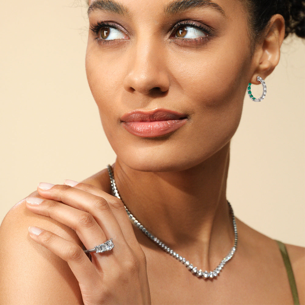 Model Wearing Inside-Out Round Shape Diamond and Created Emerald Hoop Earrings view