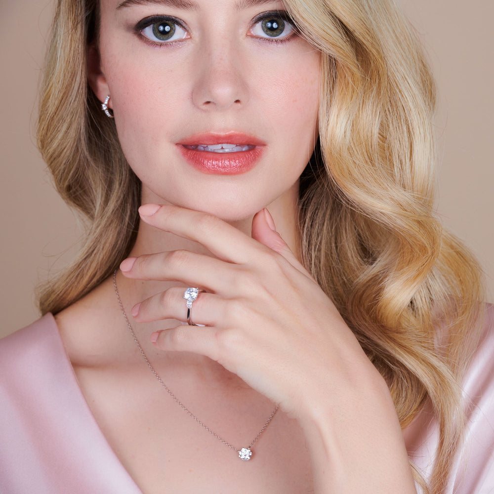 Model Wearing Fine Line Pear Three Stone Engagement Ring view