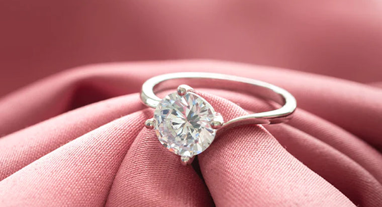Diamond Solitaire ring placed on pink cloth