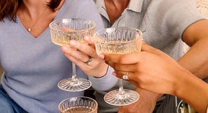 woman holding man's arm wearing a ring with a pave setting