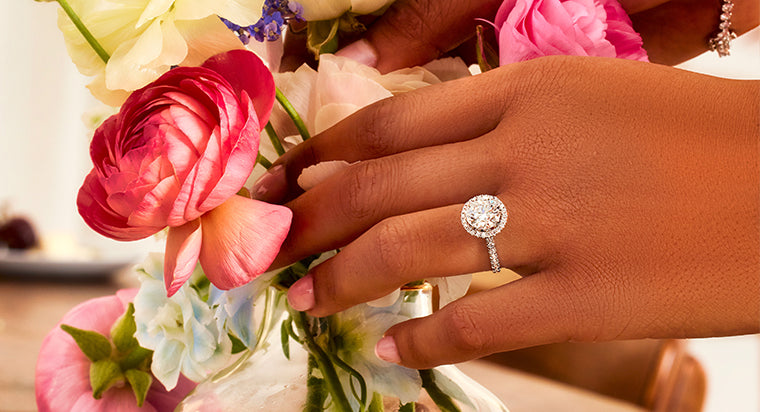 woman sliding ring on finger after engagement ring cleaning