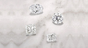 Four lab diamonds: oval, round, princess, cushion