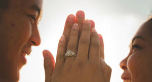 unique engagement rings couple touching hands