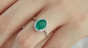 emerald engagement ring closeup on woman's finger