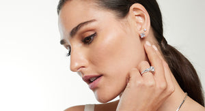 Model displaying her diamond stud earrings