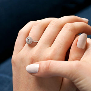 woman wearing engagement ring with accent diamonds