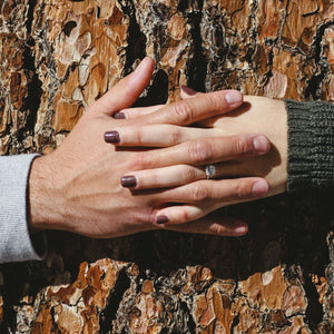 cushion cut vs princess cut couple holding hands around tree