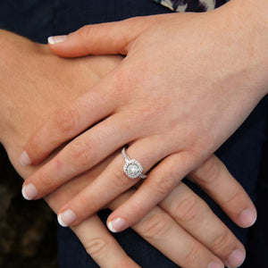 couples hands woman wearing cushion halo ring