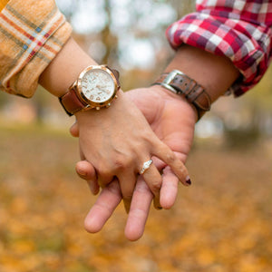 man holding woman's hand wearing channel set engagement ring