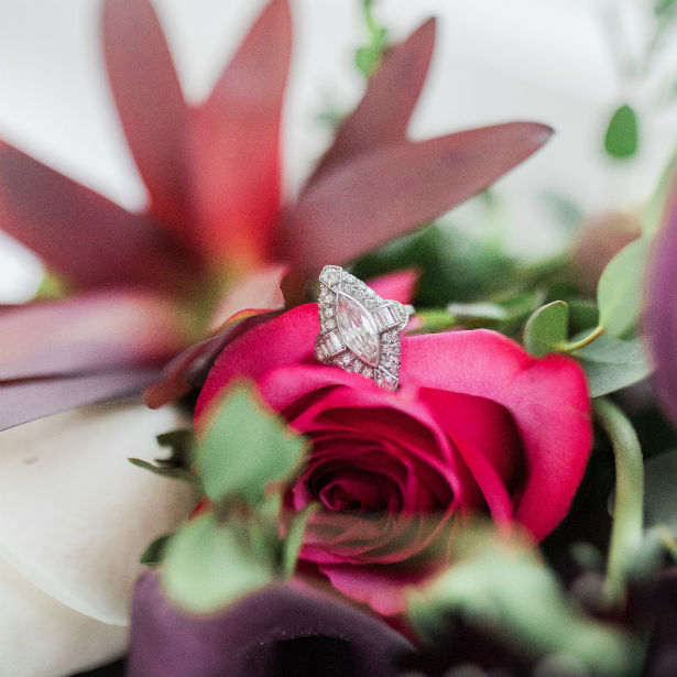 marquise engagement ring sitting on rose