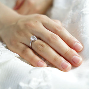 womans hands wearing ring with a 2 carat diamond