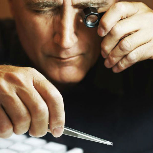 gemologist inspecting spread diamonds