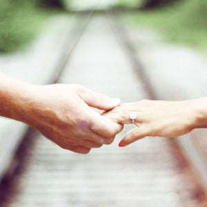 woman holding hands wearing elongated cushion cut diamond