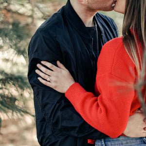 woman hugging fiance wearing non diamond engagement ring