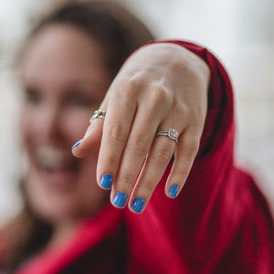 woman showing off split shank enaggement ring