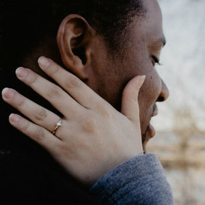 woman tuching fiances face wearing engagement ring
