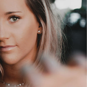 woman wearing diamond earrings