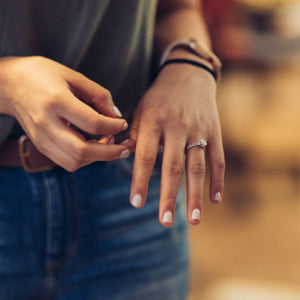 woman wearing infinity engagement ring