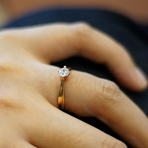womans hand wearing cute engagement ring