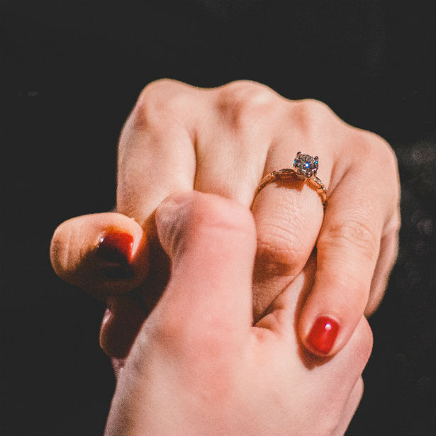 woman's hand wearing engagement ring