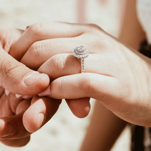 woman's hand wearing ring with floating halo