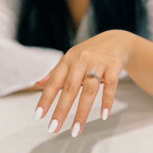 woman's outstretched hand wearing engagement ring