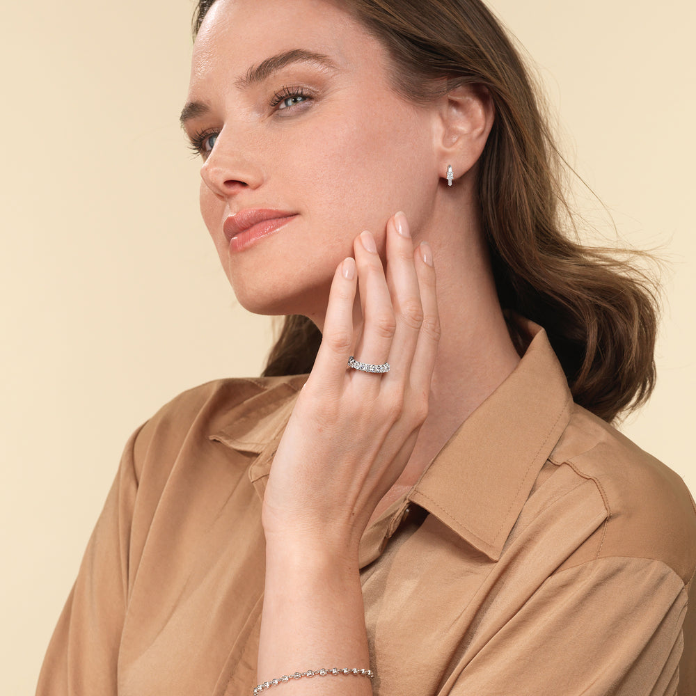 Model Wearing Created Oval Solitaire Knife Edge Huggies view