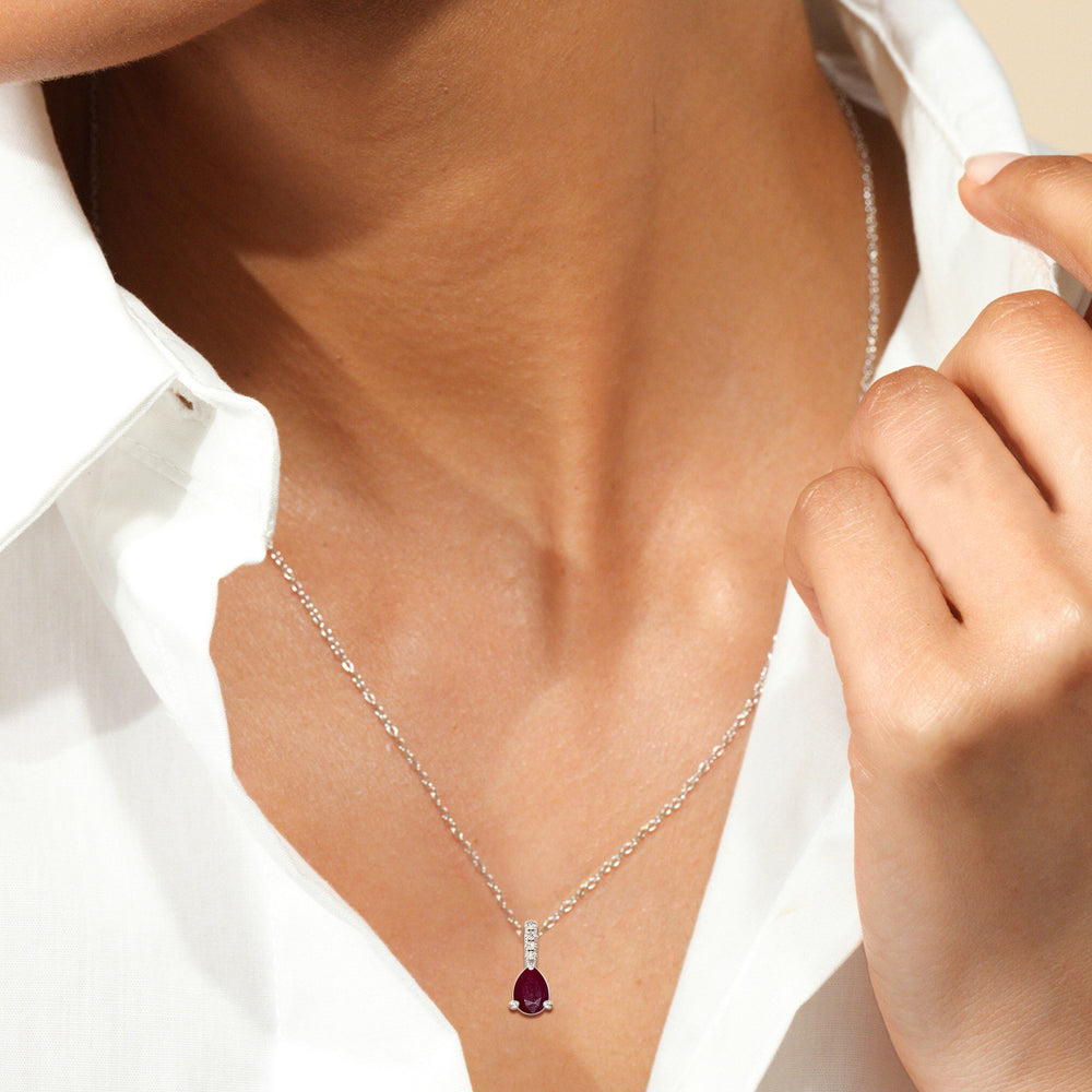 Model Wearing Pear Ruby and Lab Diamond Classic Solitaire Pendant With Studded Bale view