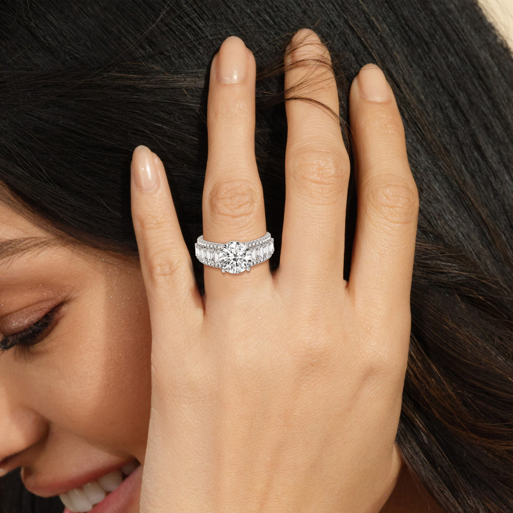 Model Wearing Emerald Side Stone Broad Band Hidden Halo Engagement Ring view