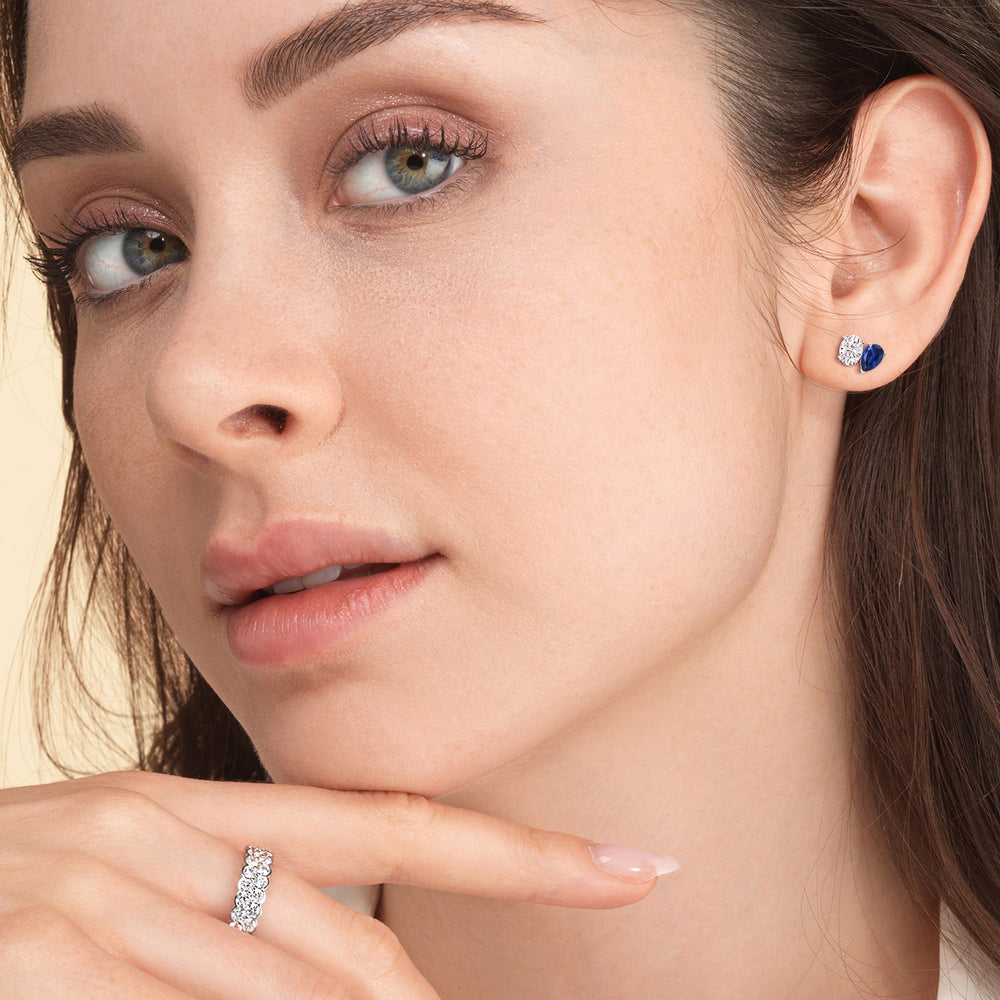 Model Wearing Toi et Moi Created Sapphire Pear and Oval Diamond Stud Earrings view