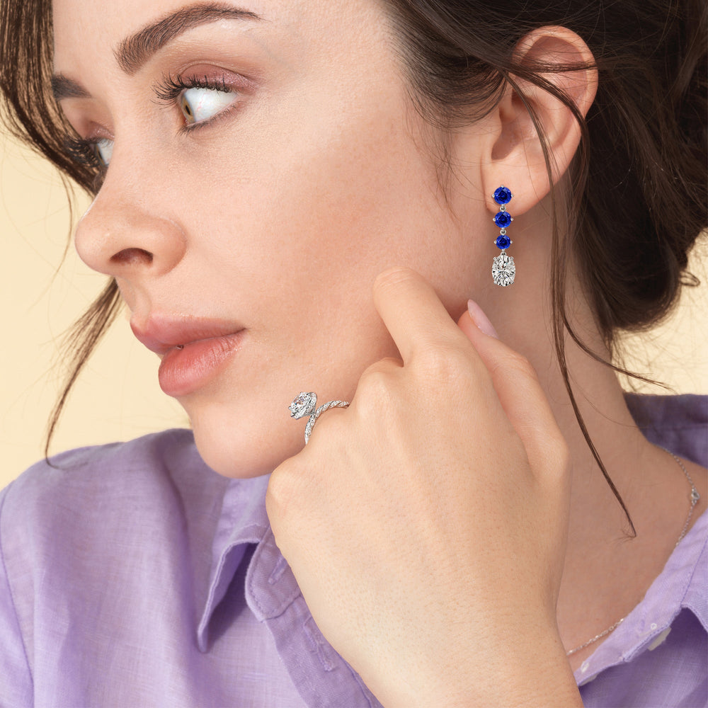 Model Wearing Elegance Oval Diamond and Created Sapphire Dangler Earrings view