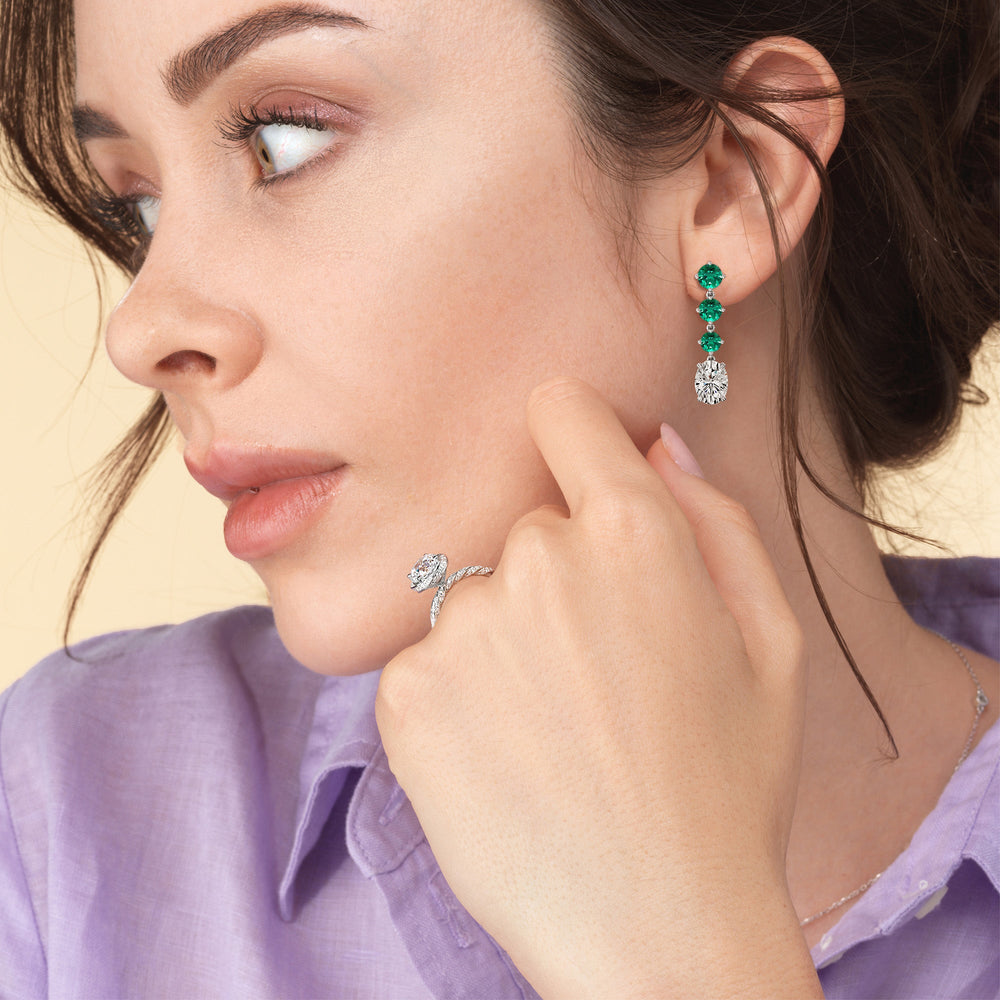 Model Wearing Elegance Oval Diamond and Created Emerald Dangler Earrings view