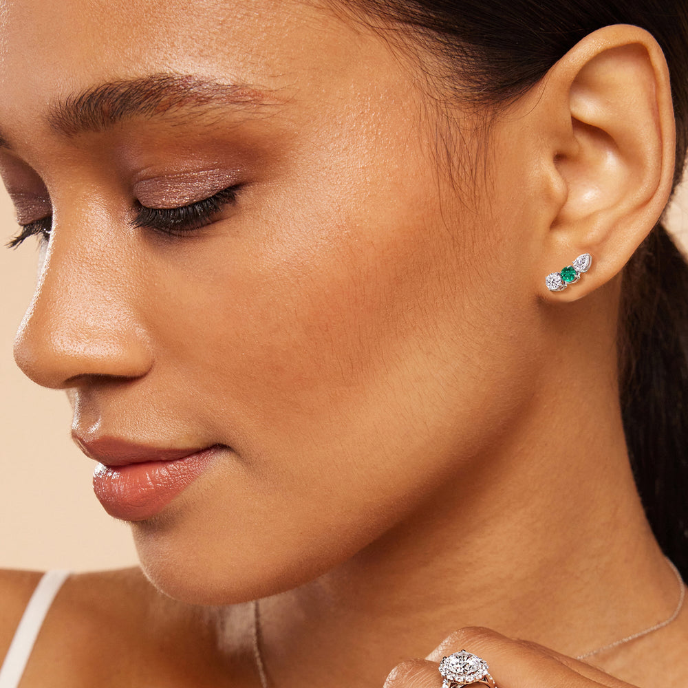 Model Wearing Trilogy Round and Pear Diamond and Created Emerald Climber Earrings view