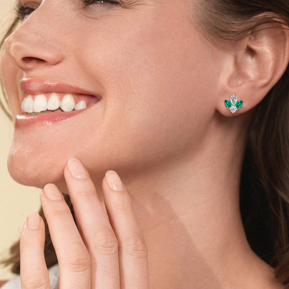 Model Wearing Classic Pear Created Emerald and Round Diamonds Cluster Earrings view
