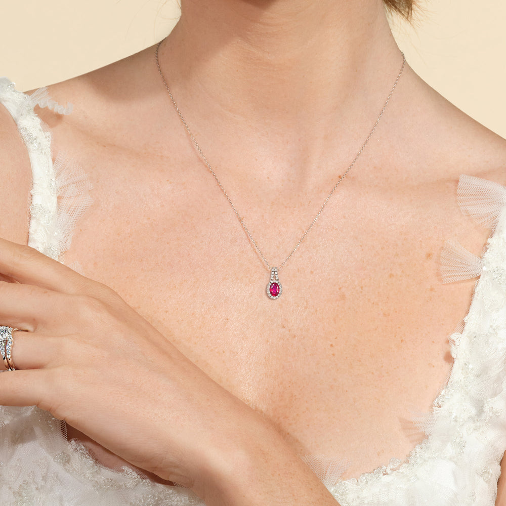 Model Wearing Oval Created Ruby and Lab Diamond Classic Halo Pendant With Studded Split Bale view