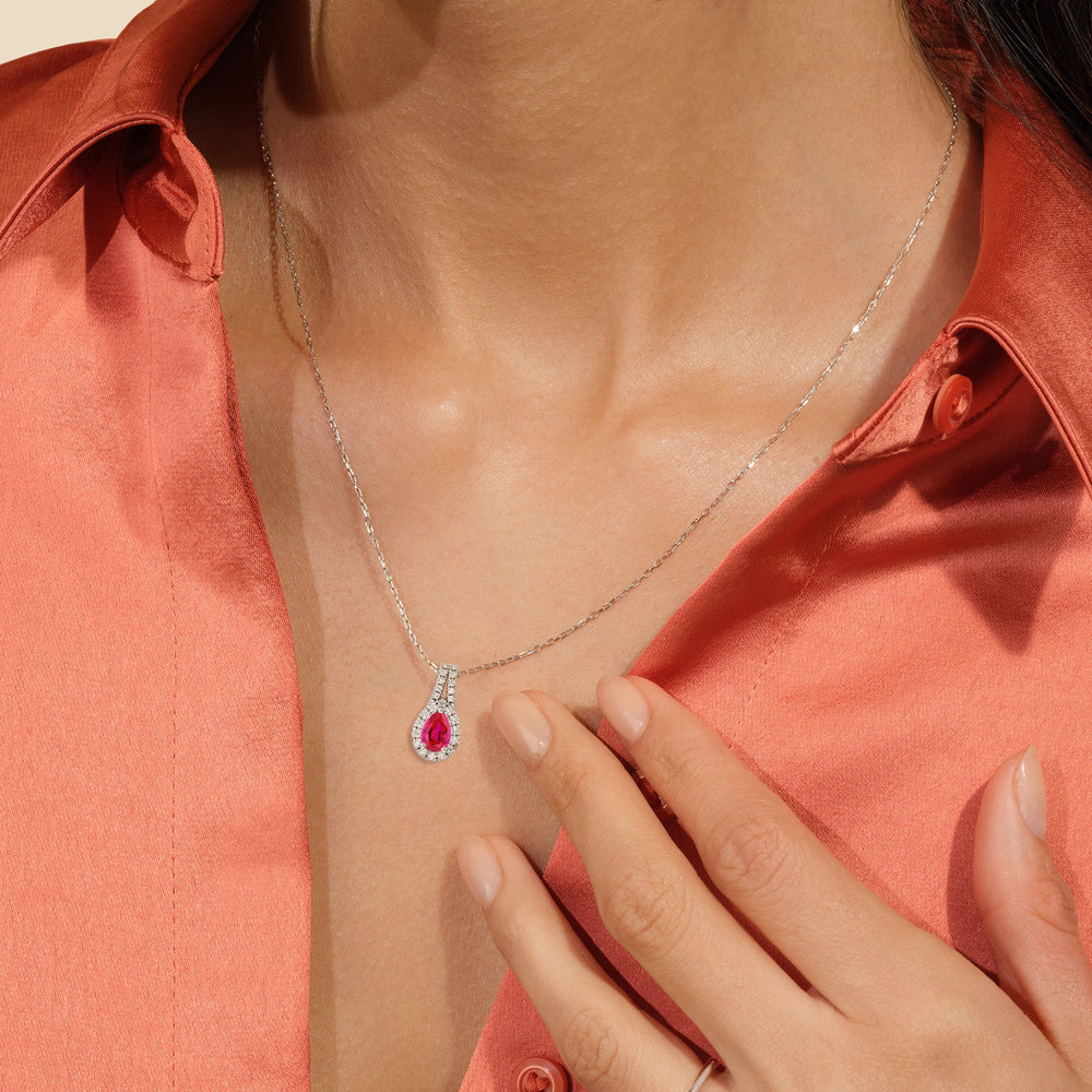 Model Wearing Pear Created Ruby and Lab Diamond Classic Halo Pendant With Studded Split Bale view