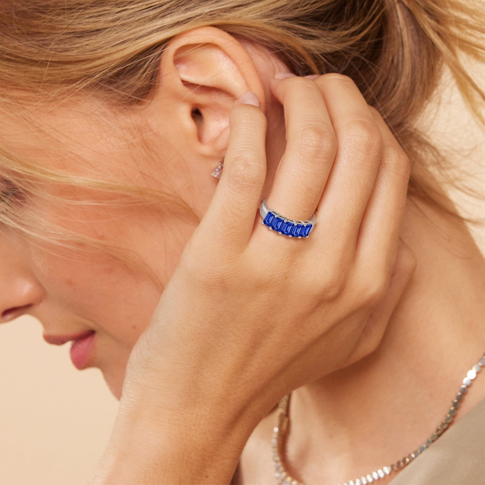 Model Wearing Five Stone Created Sapphire Emerald Cut Anniversary Ring view