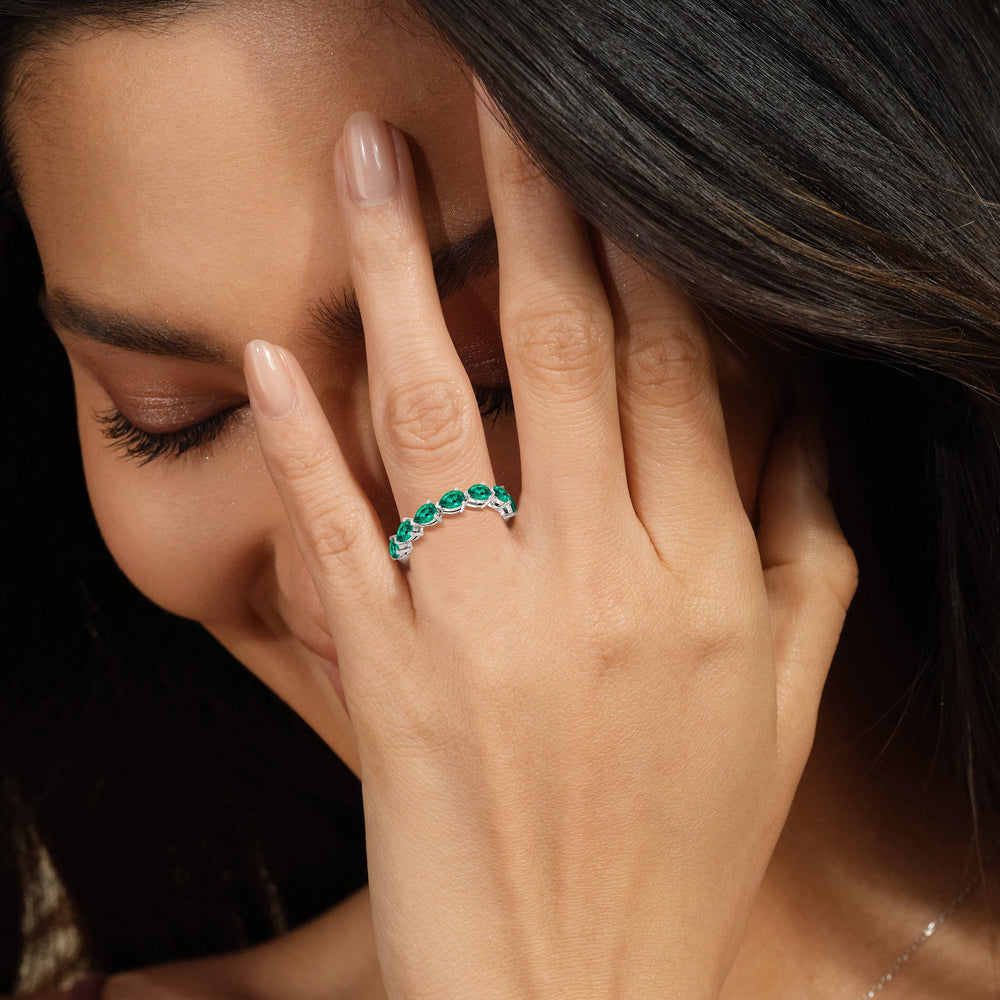 Model Wearing Trailing Created Emerald Pear Shape Anniversary Ring view