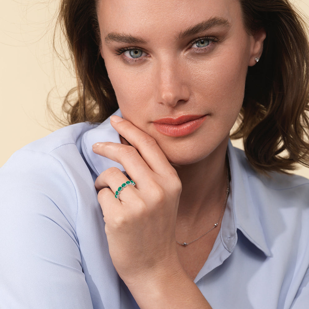 Model Wearing Trailing Created Emerald Pear Shape Anniversary Ring view