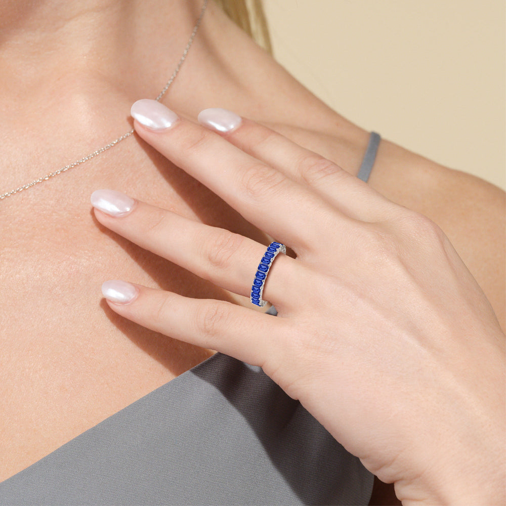 Model Wearing Created Sapphire Emerald Split Prong Basket Eternity Ring Size 6.25 view